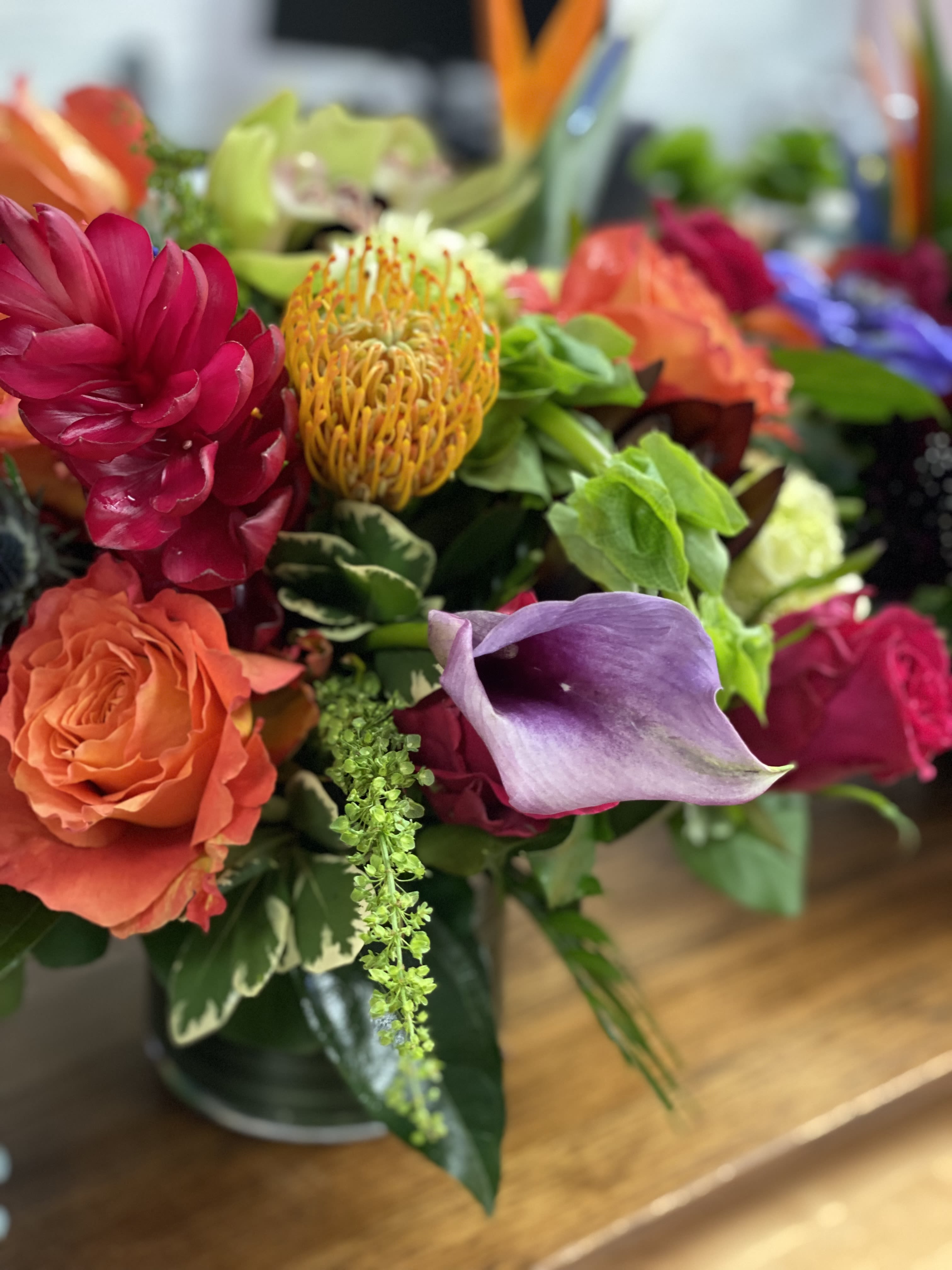 Designer's Choice Tropical Twist - Uniquely made tropical mix of exotic blooms and traditional flowers in a glass cube or cylinder