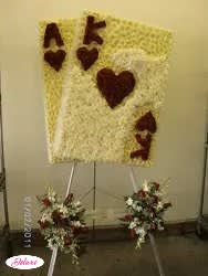 Heart-shaped floral tribute on an easel with two smaller matching sprays below