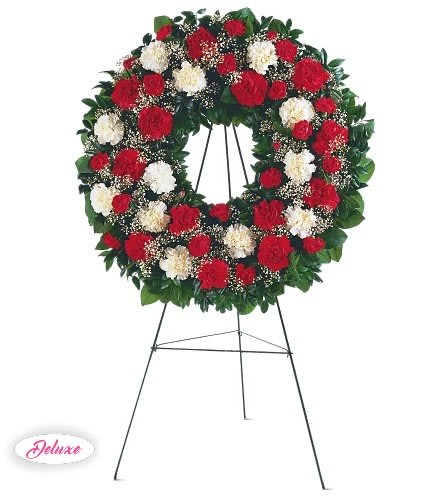 Red and white carnation wreath on a standing easel