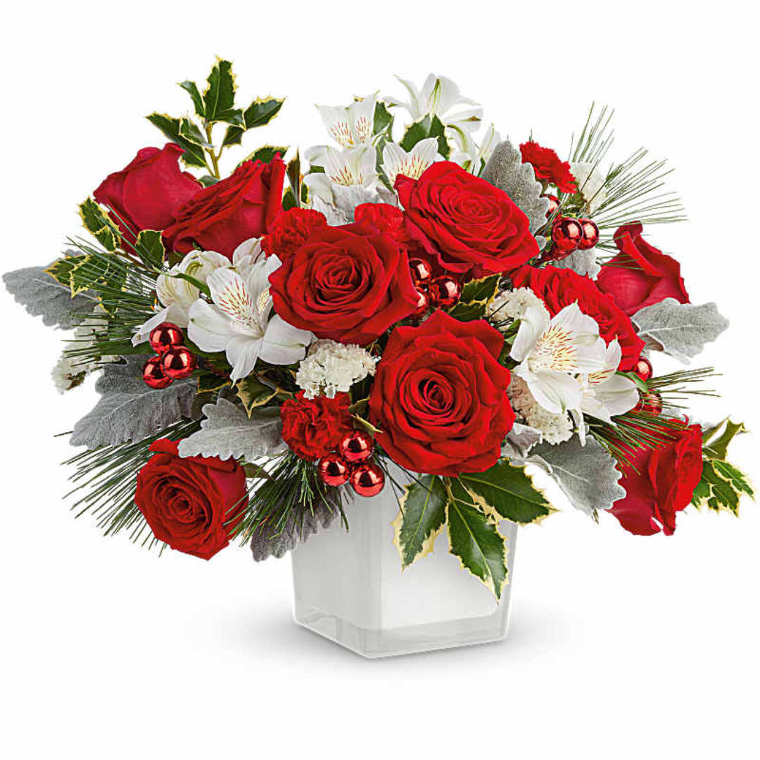 Red roses and white lilies in a clear square vase