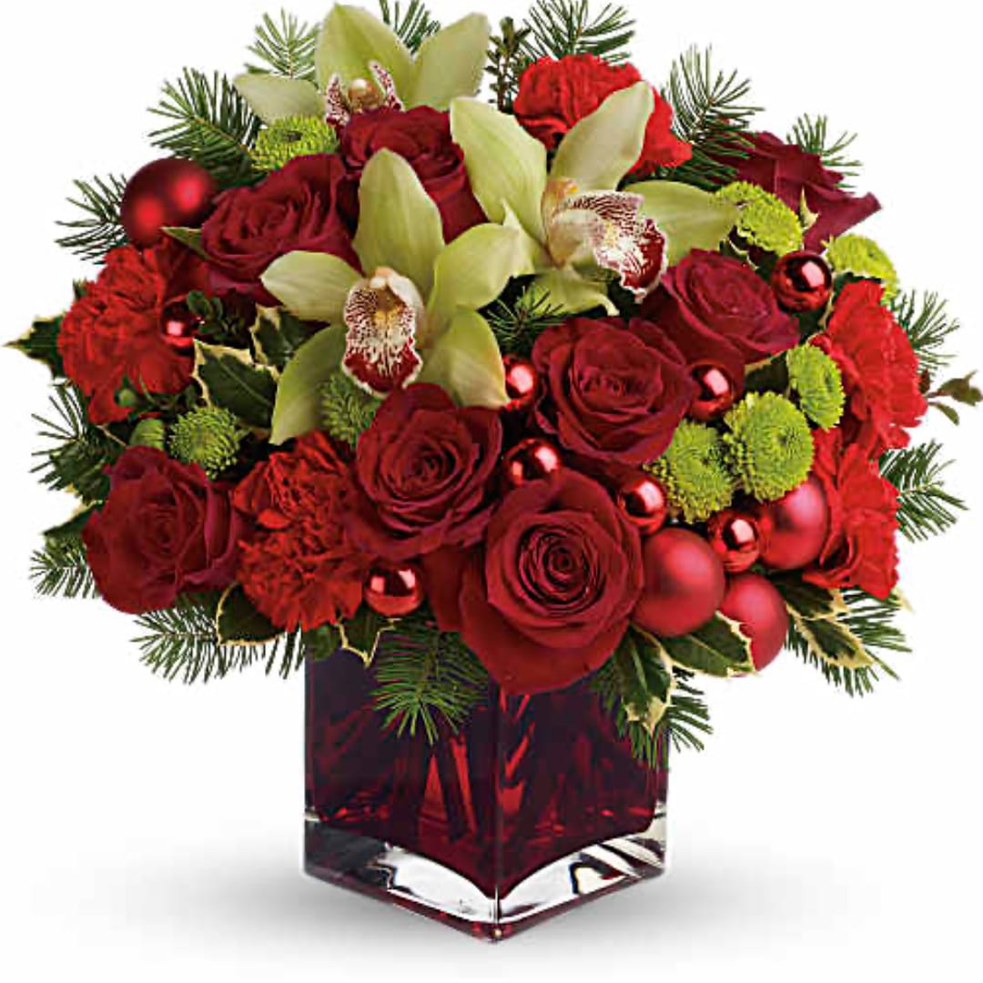 Red roses and pale green orchids in a red glass vase
