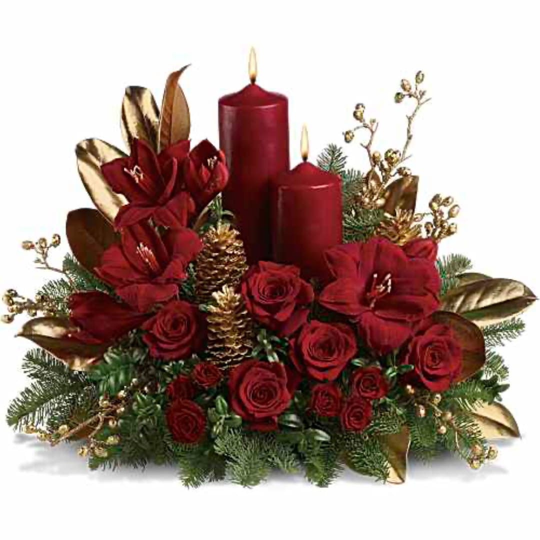 Red roses arranged with two red candles and gold accents