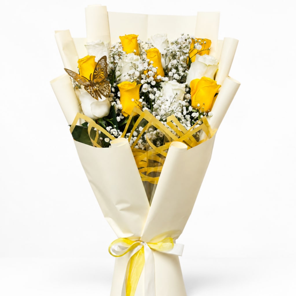 Bouquet of yellow and white roses wrapped in cream paper