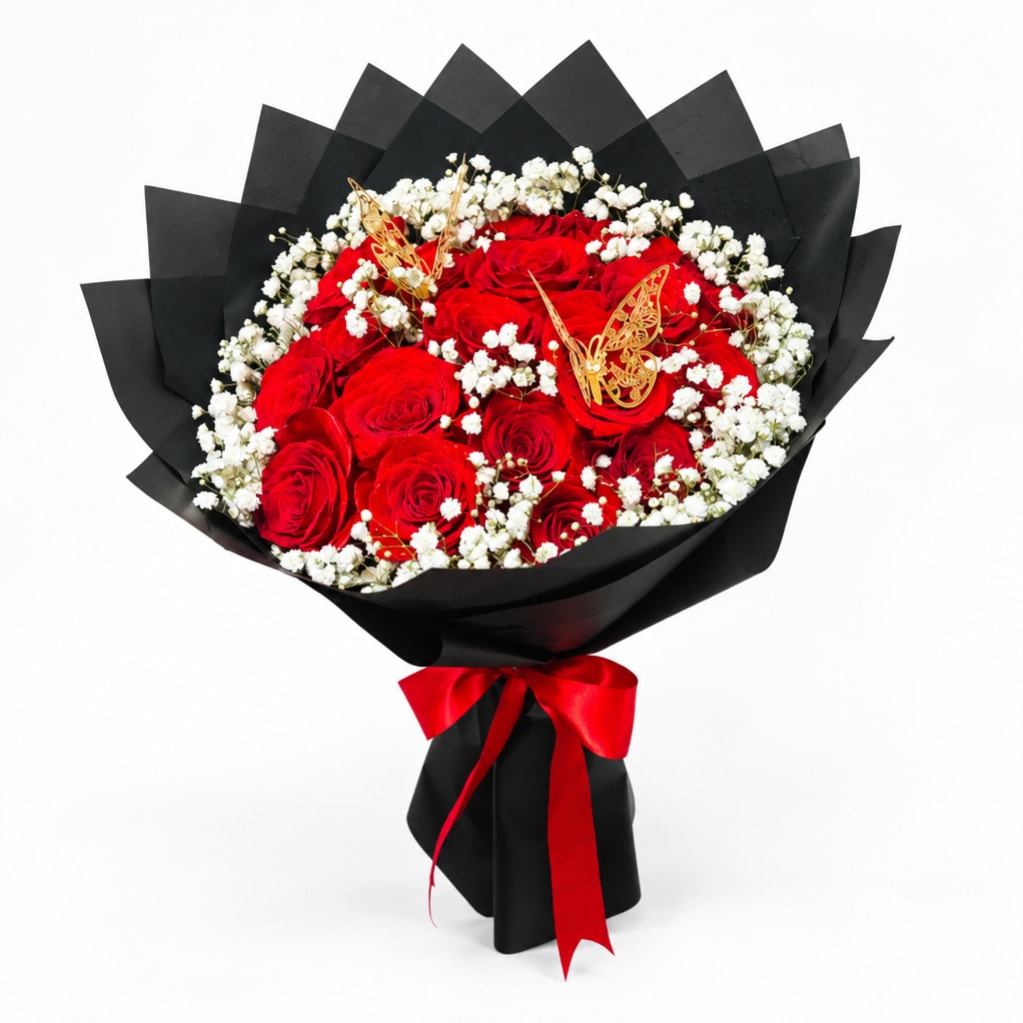 Bouquet of red roses with white baby's breath wrapped in black paper and a red ribbon