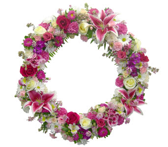 K617  Floral Wreath I - Select pink and white flowers compliment this memorable wreath featuring stargazer lilies. Available in many color combinations.  Please call one of our sales associates to discuss different size and color options.