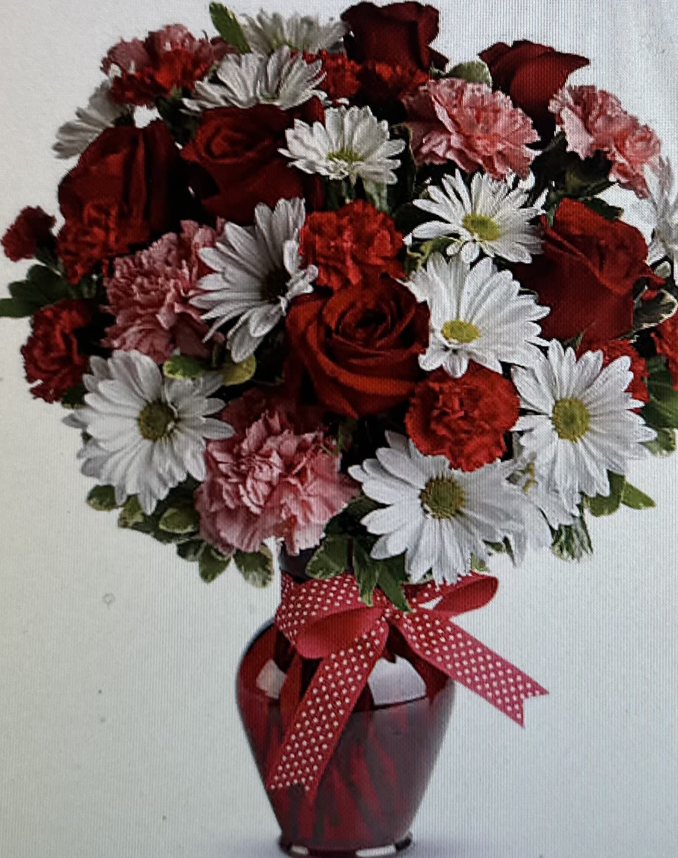 LOVE ME DO BOUQUET - RED AND WHITE BOUQUET OF DAISIES, RED ROSES, PINK CARNATIONS, RED MINI CARNS IN A RED VASE WITH RED RIBBON