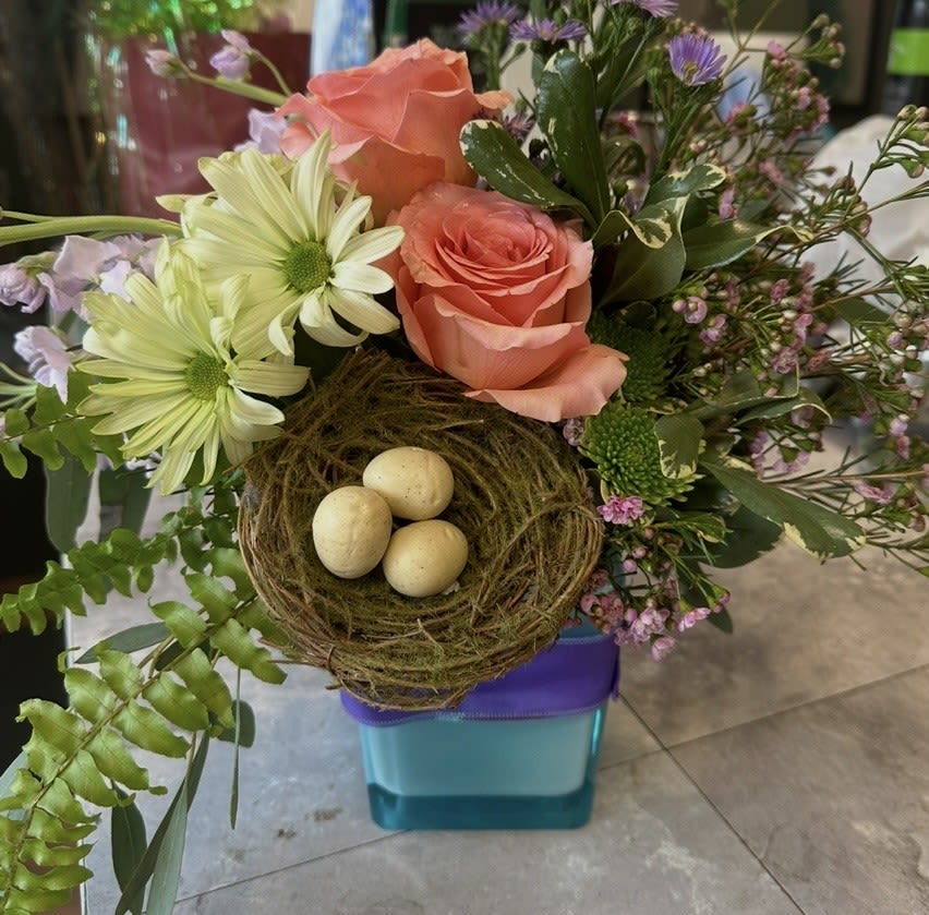 SPRING HAS SPRUNG - CUTE CUBE OF ROSES DAISIES FERN AND FILLERS AND GREENS WITH AN EGG NEST  COLOR OF CUBE MAY VARY