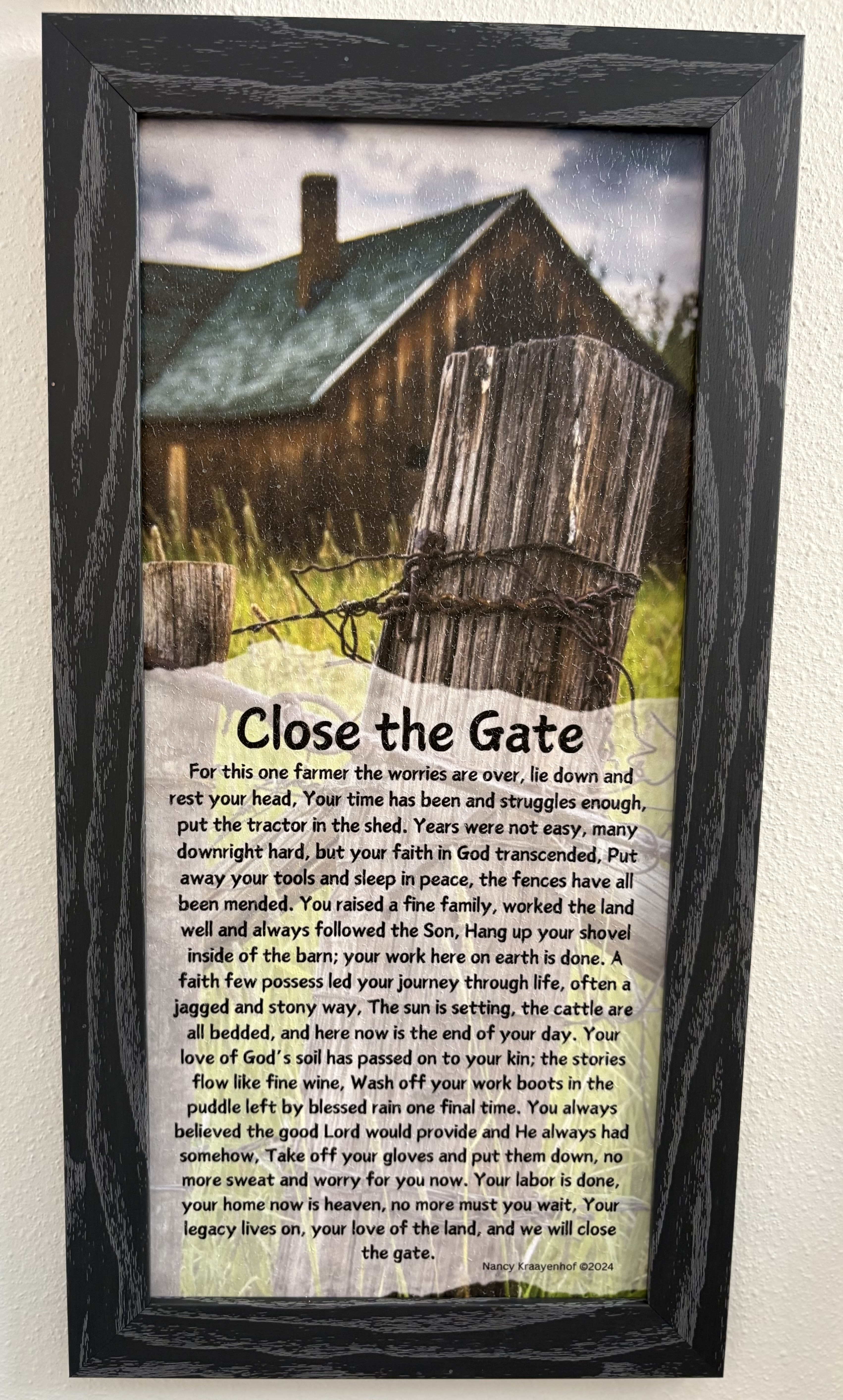 Framed memorial sign with a farm gate and poem text