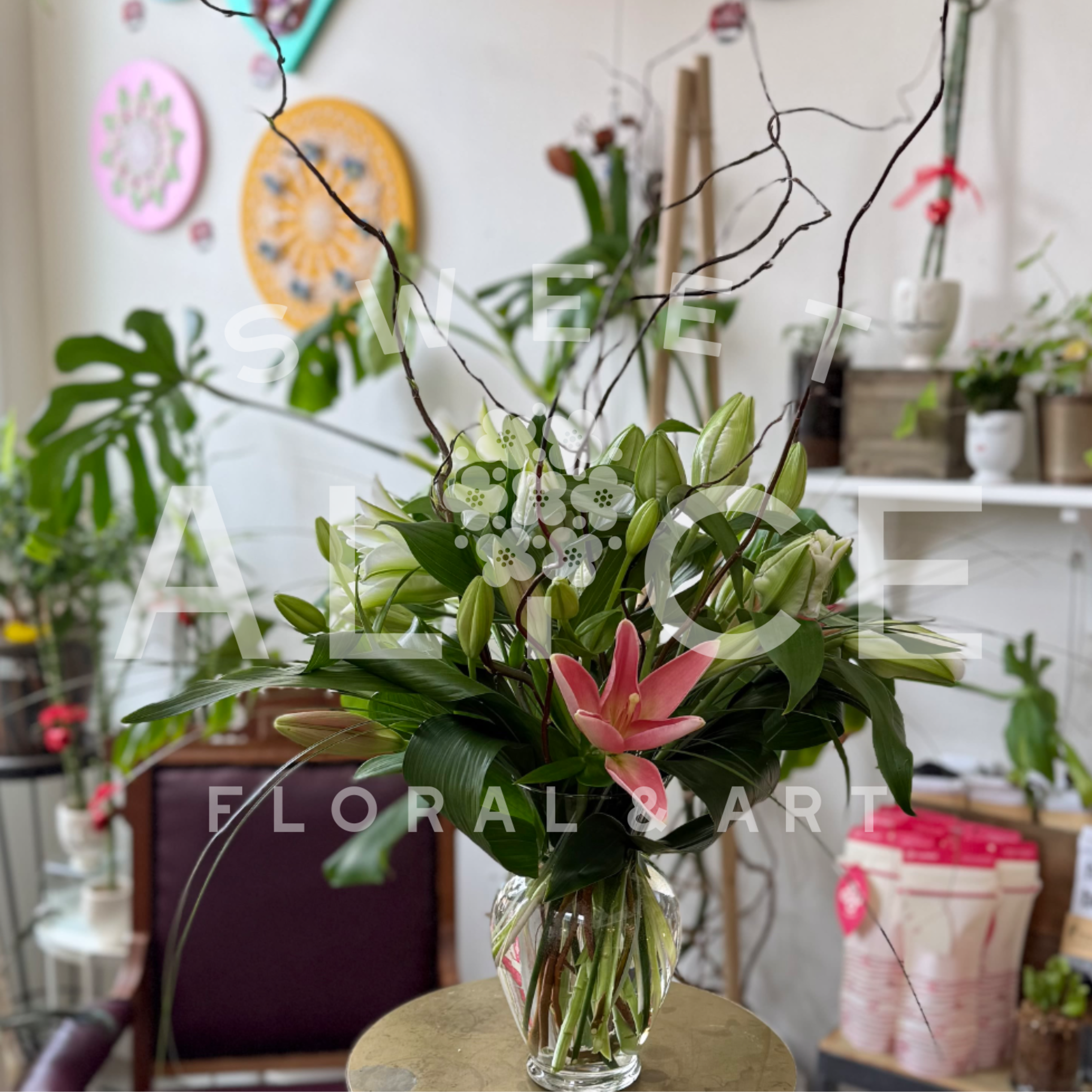 Lily Love - A beautiful mix of asiatic and oriental lilies with assorted greens and curly willow.