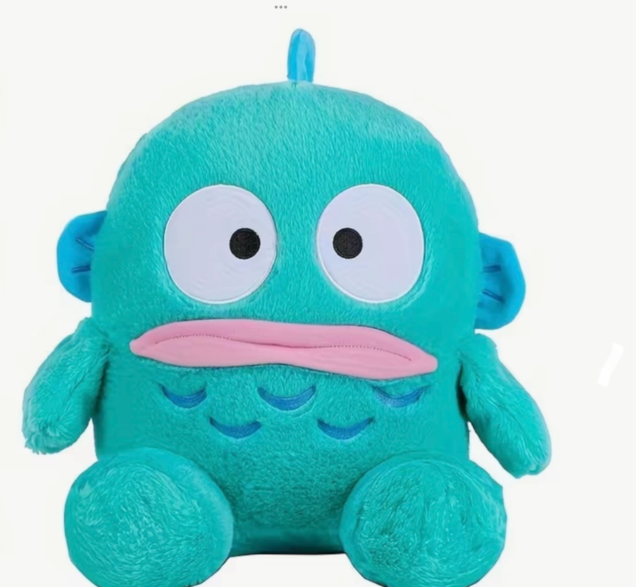 Teal plush monster toy with big eyes and pink mouth