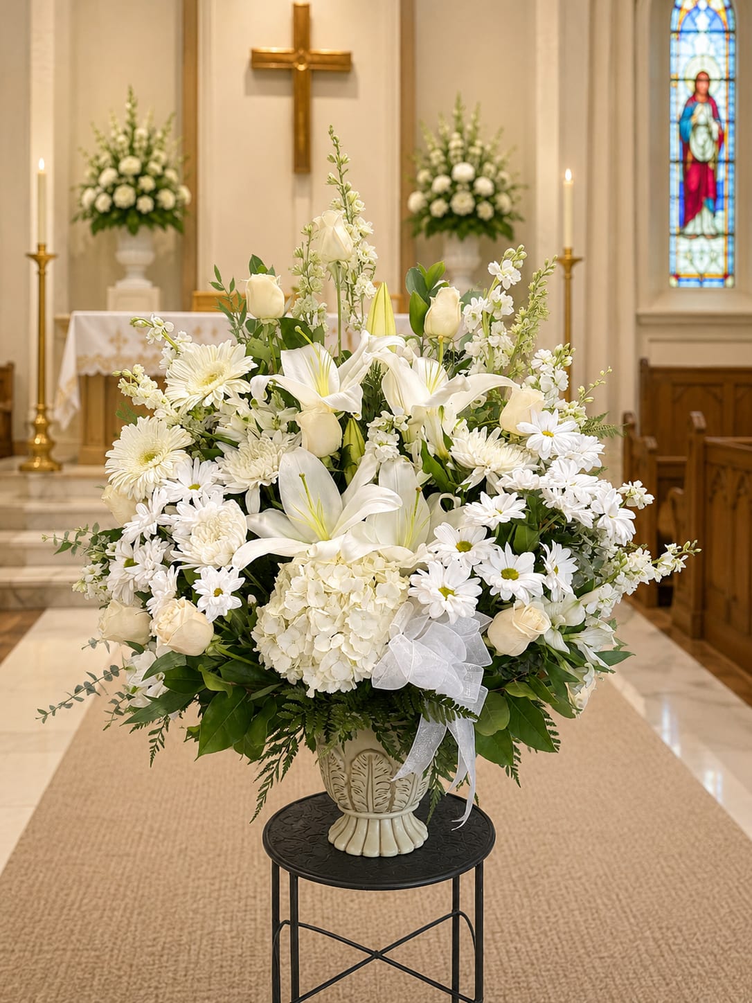 White floral arrangement in a vase inside a church