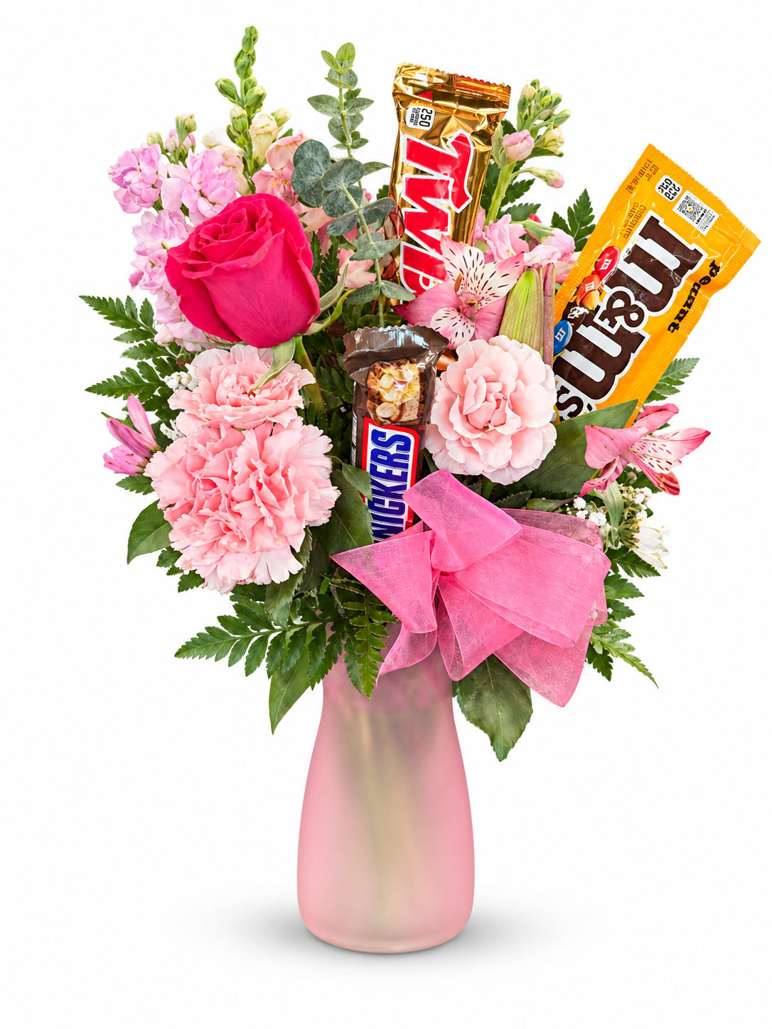Pink floral bouquet in a frosted vase with candy bars and a pink bow
