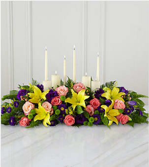 The FTD® Forever™ Arrangement - This inspirational altar piece handcrafted by a local FTD artisan florists makes an inspired contribution to a funeral service - one that truly shows how much you care. Handcrafted by a local FTD artisan florist of peach and coral roses, purple lisianthus and asters, yellow Asiatic lilies and lush green accents in a long, low arrangement, it makes a natural setting for a variety of candles (included). As an accompaniment to a funeral, it's an excellent choice for most services both elaborate and simple. Your purchase includes a complimentary personalized gift message.