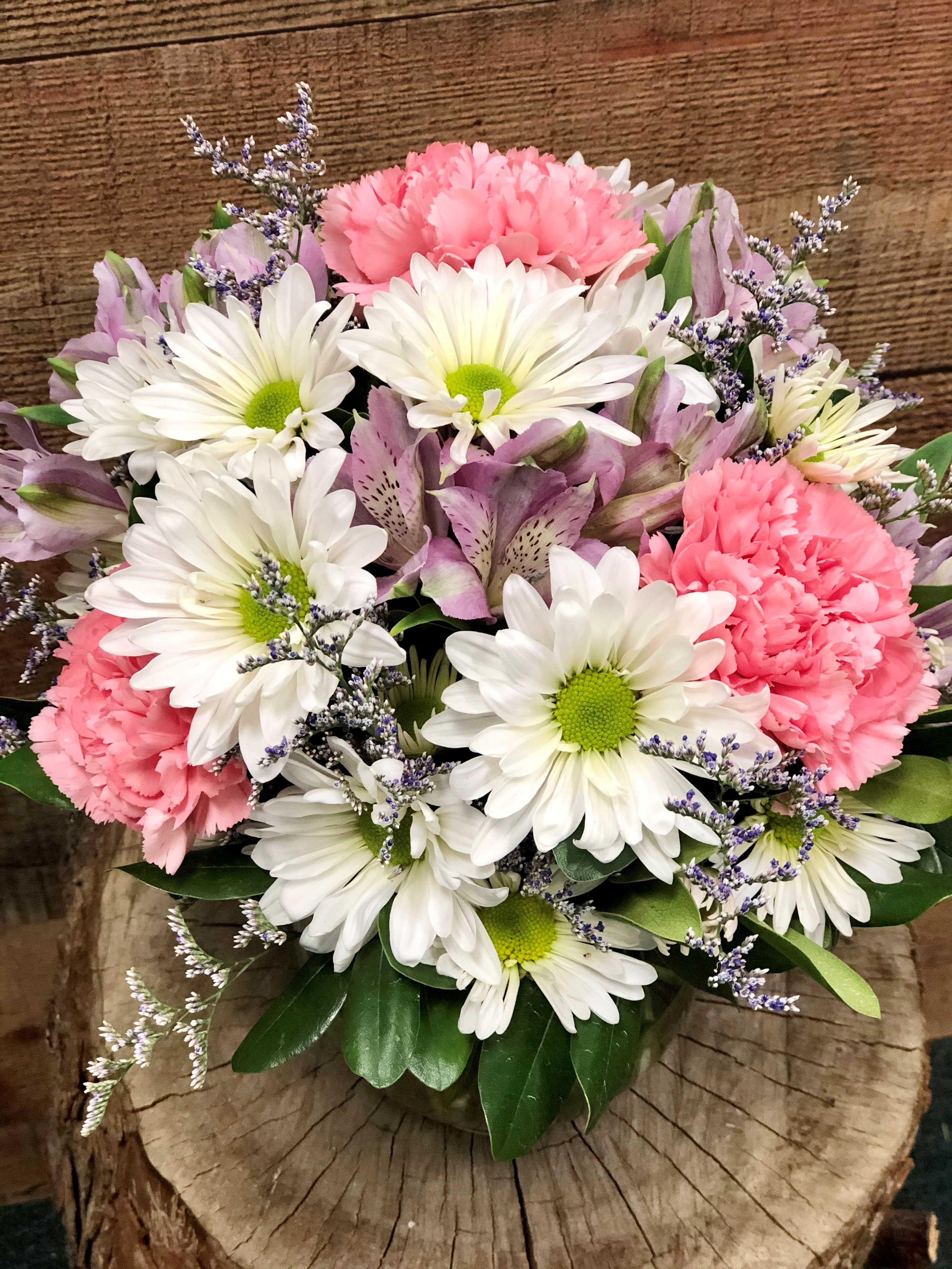 Bouquet of white daisies, pink carnations, and lavender flowers