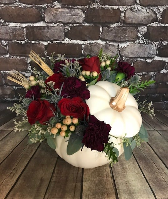 Pumpkin-shaped arrangement with red roses and burgundy flowers