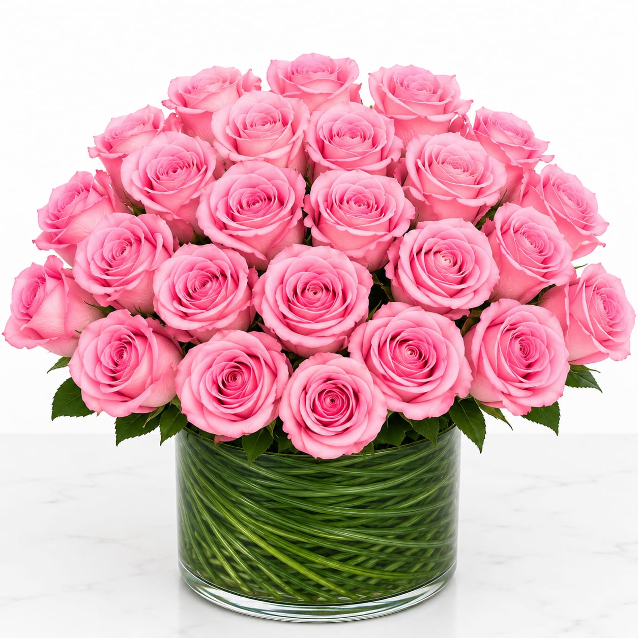 Pink roses arranged in a clear glass vase
