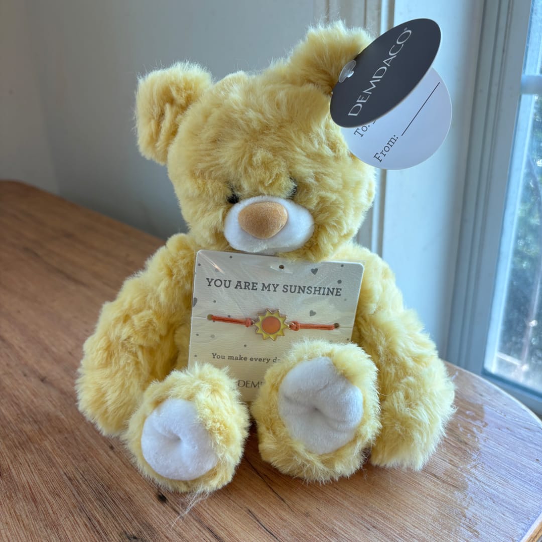 Yellow teddy bear holding a sunshine bracelet card