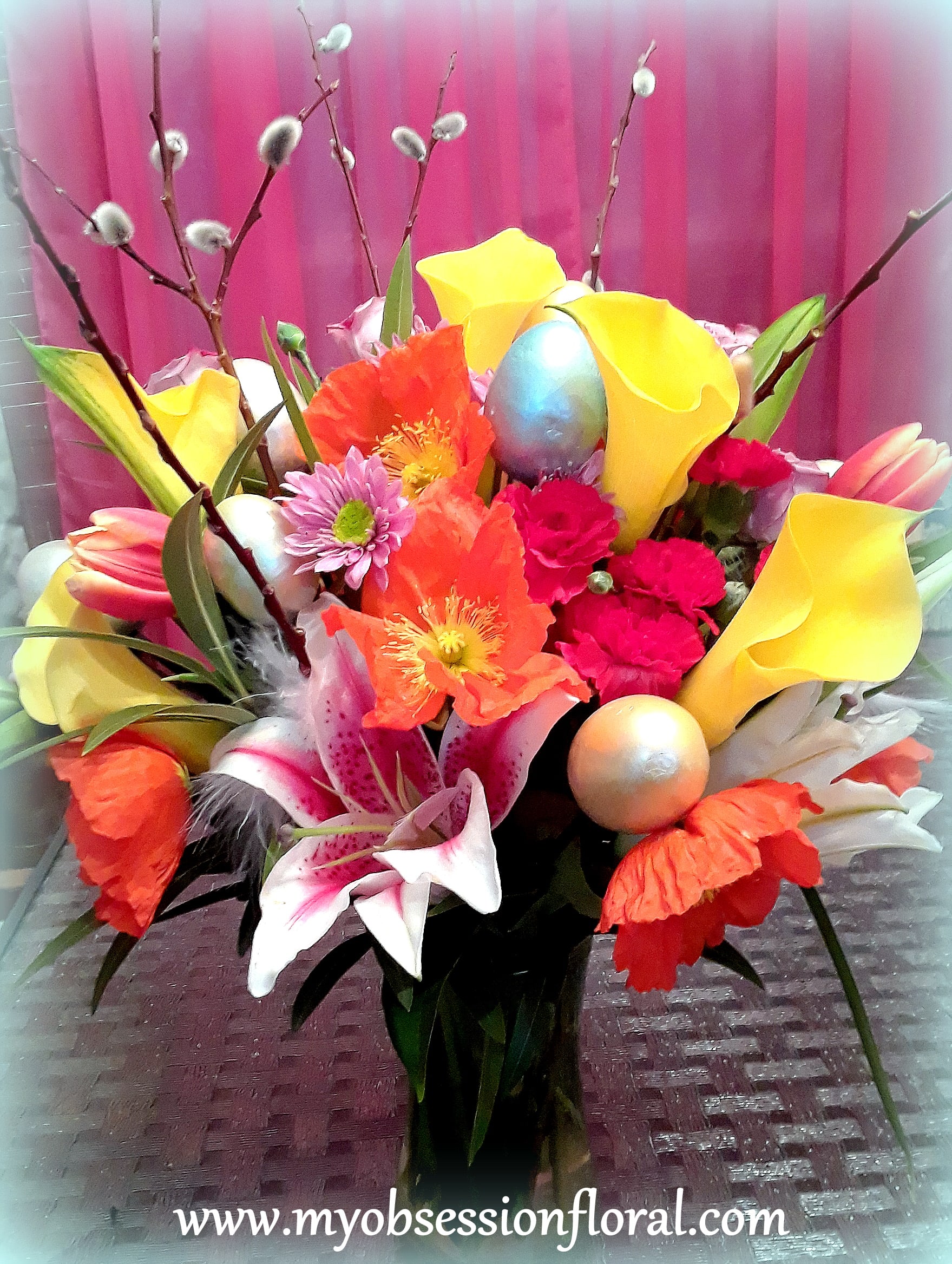 Colorful bouquet with calla lilies, lilies, and poppy-like blooms