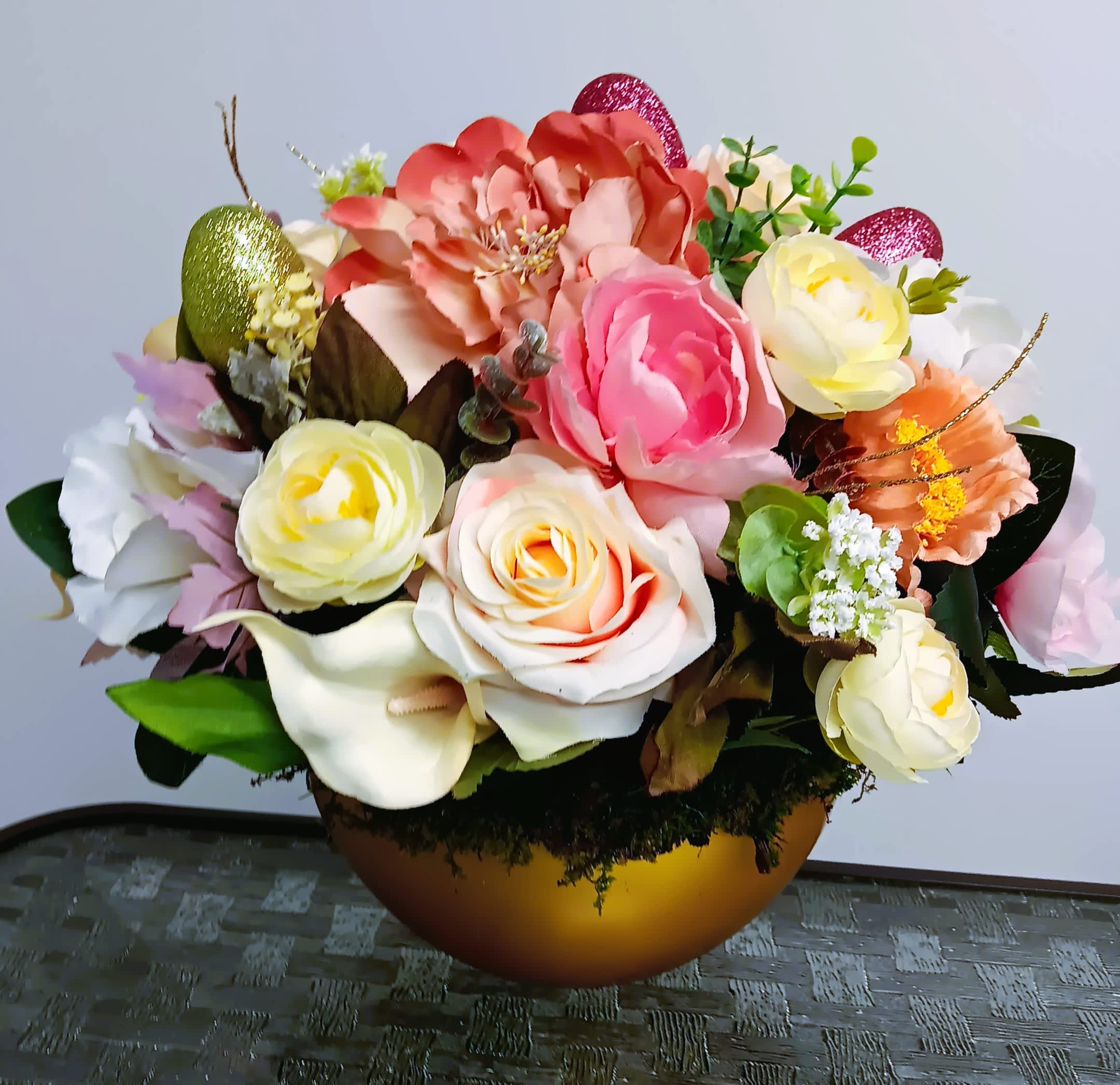 Silk arrangement of pastel roses, peonies, and calla lilies in a gold bowl with glitter accents.