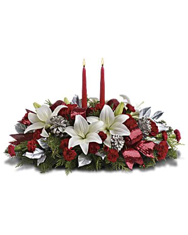 Red and white floral centerpiece with two red candles