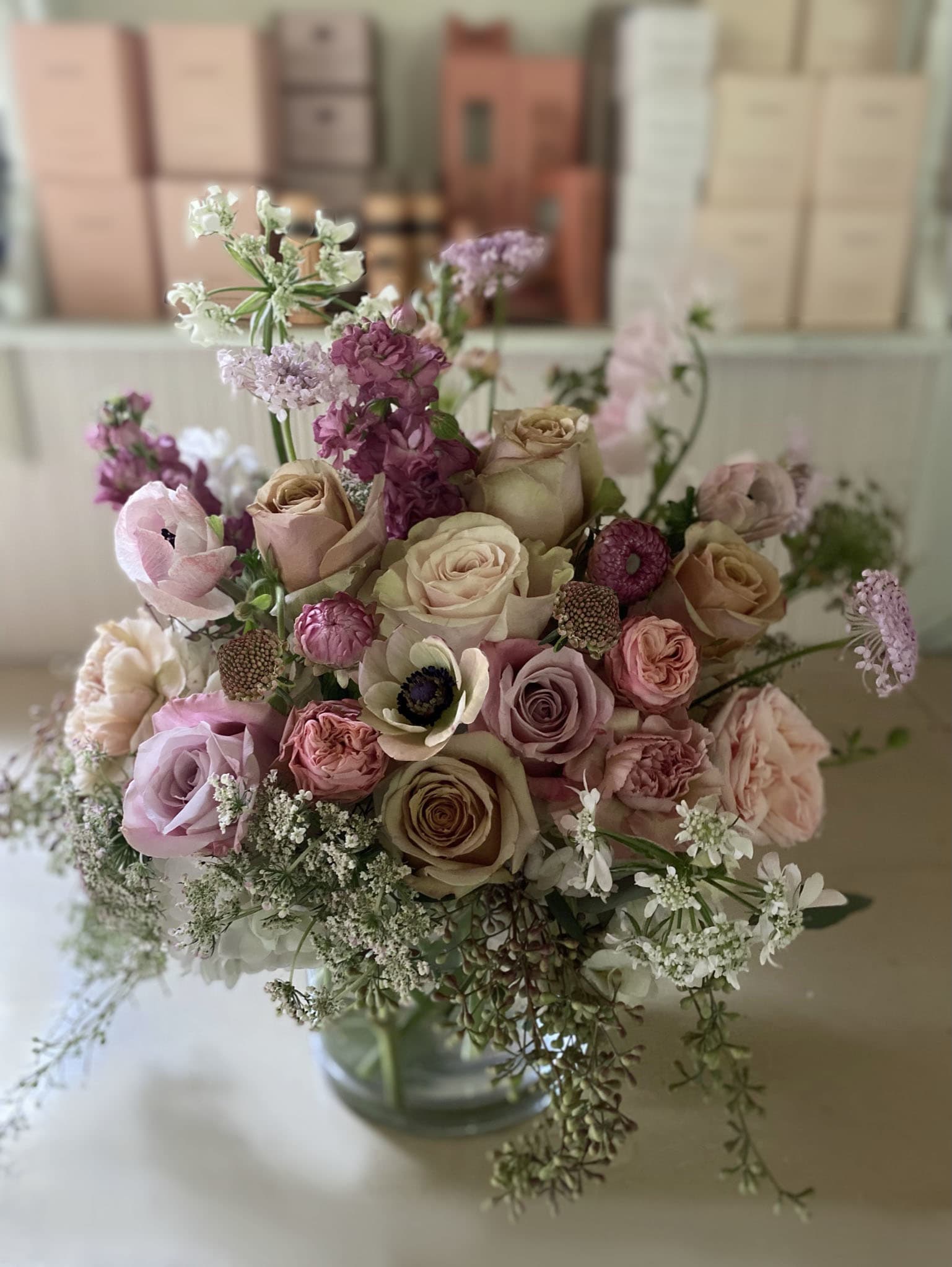 Mixed bouquet of pink and cream roses in a glass vase