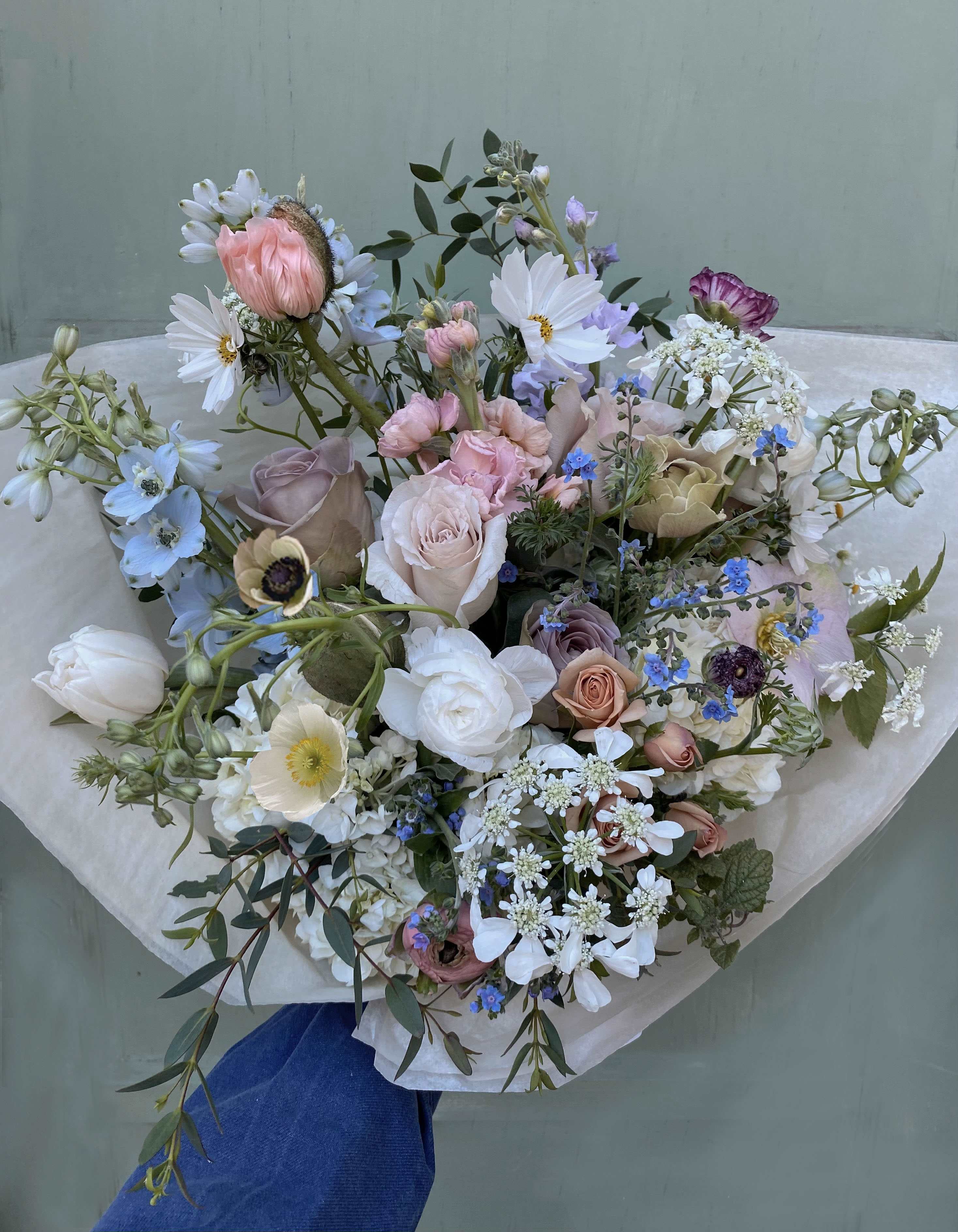Dorset dream bouquet - A gorgeous wild bouquet of natural stems including pretty nuances of blue. Poppies, Forget me nots, helleborus, Queen Anne's lace and/or other seasonal stems of loveliness in a classic, hand tied bouquet inspired by English gardens, wrapped beautifully.