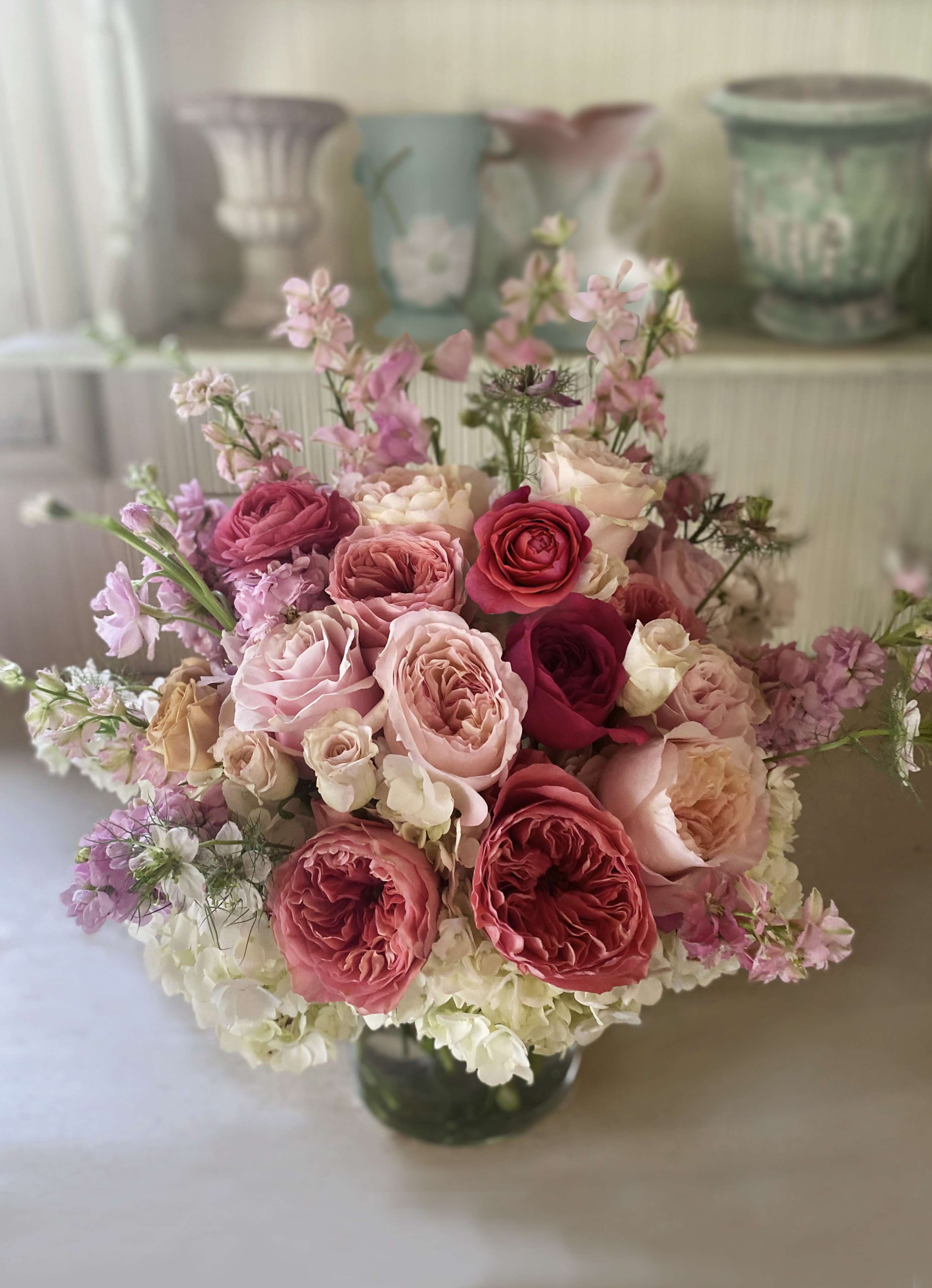 Pink and cream rose bouquet in a glass vase