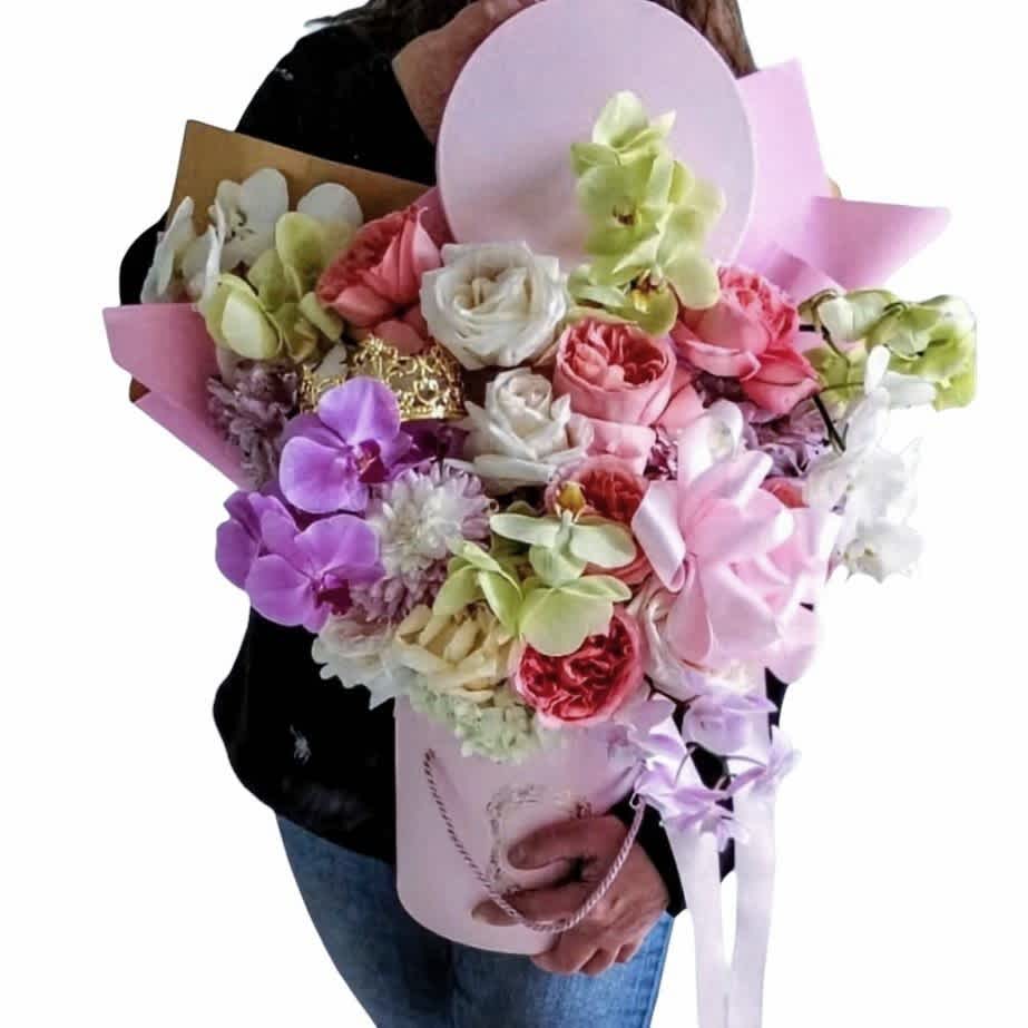 Large pastel bouquet with orchids and roses in a pink wrap