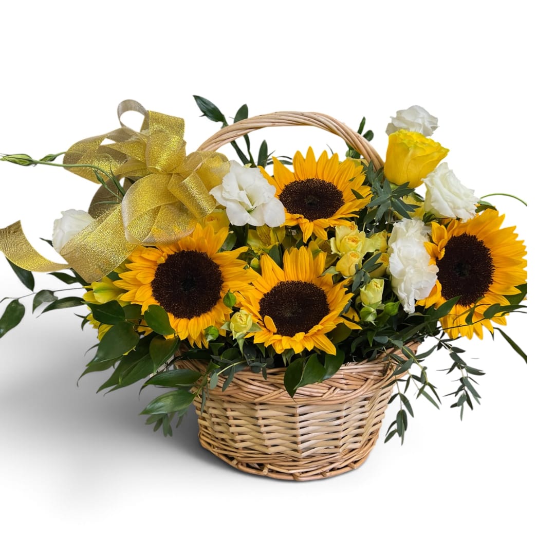 Sunflowers and white roses in a wicker basket with a gold ribbon