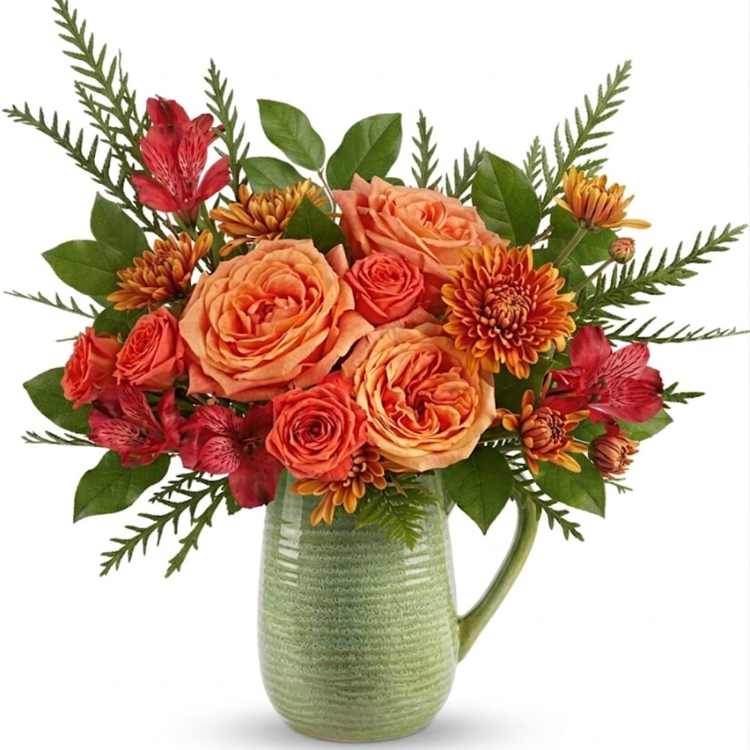 Orange roses and red alstroemeria in a green ceramic pitcher