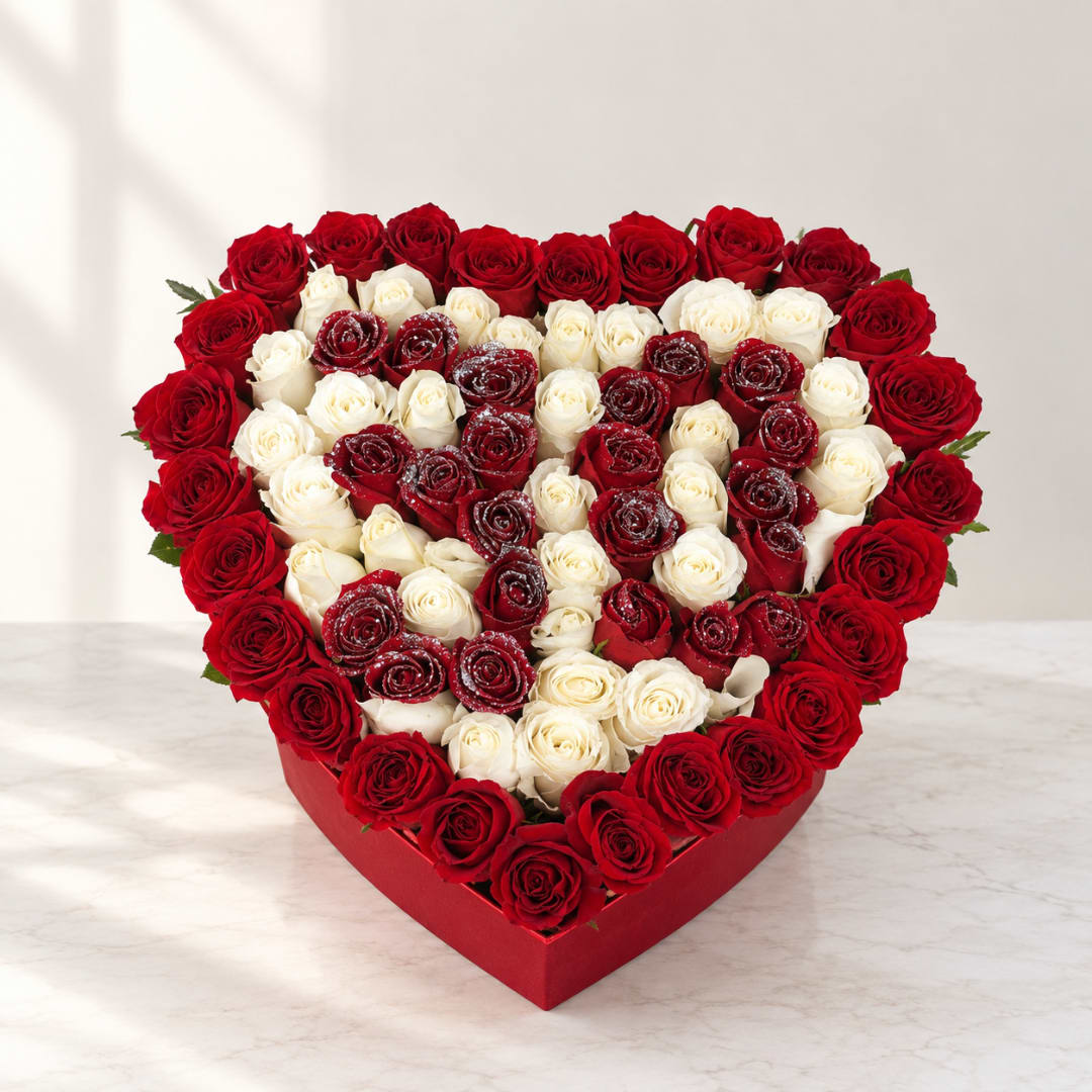 Heart-shaped box filled with red and white roses