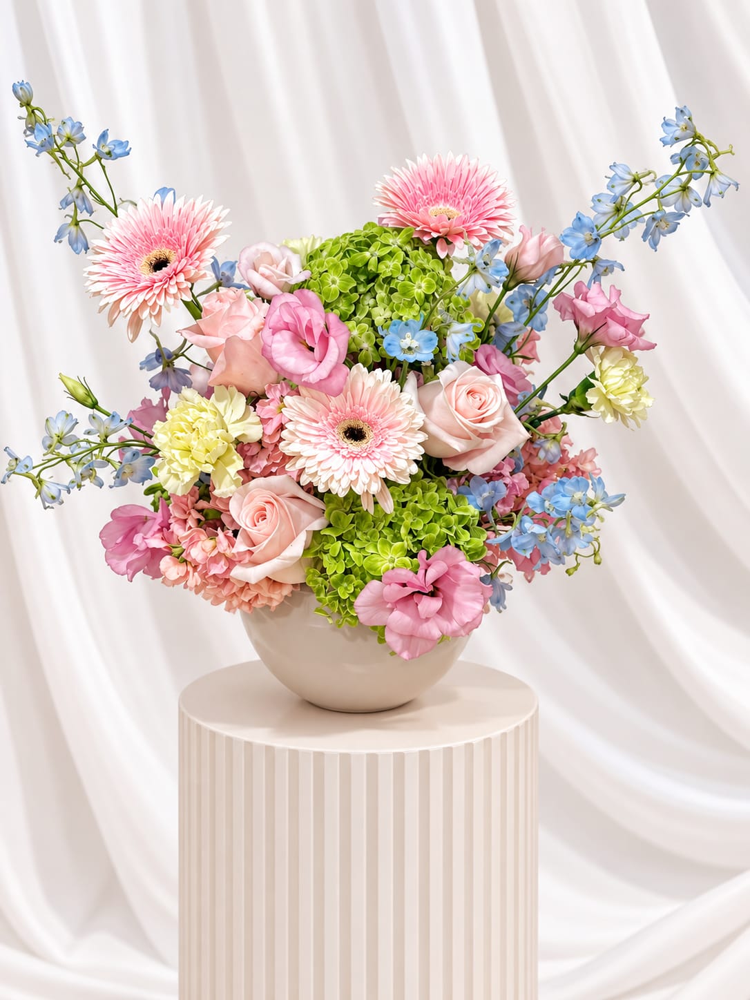 Pink and blue mixed bouquet in a round vase