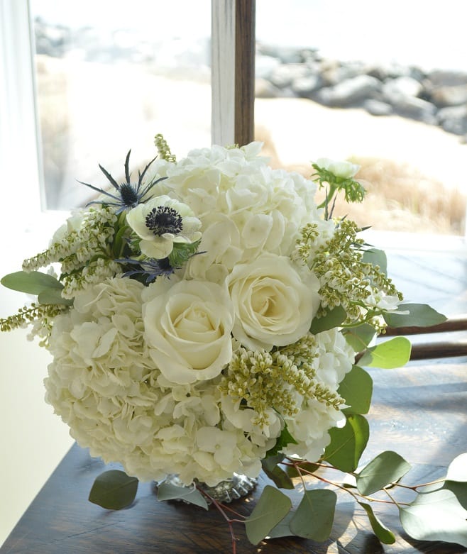 White rose and hydrangea bouquet with green foliage