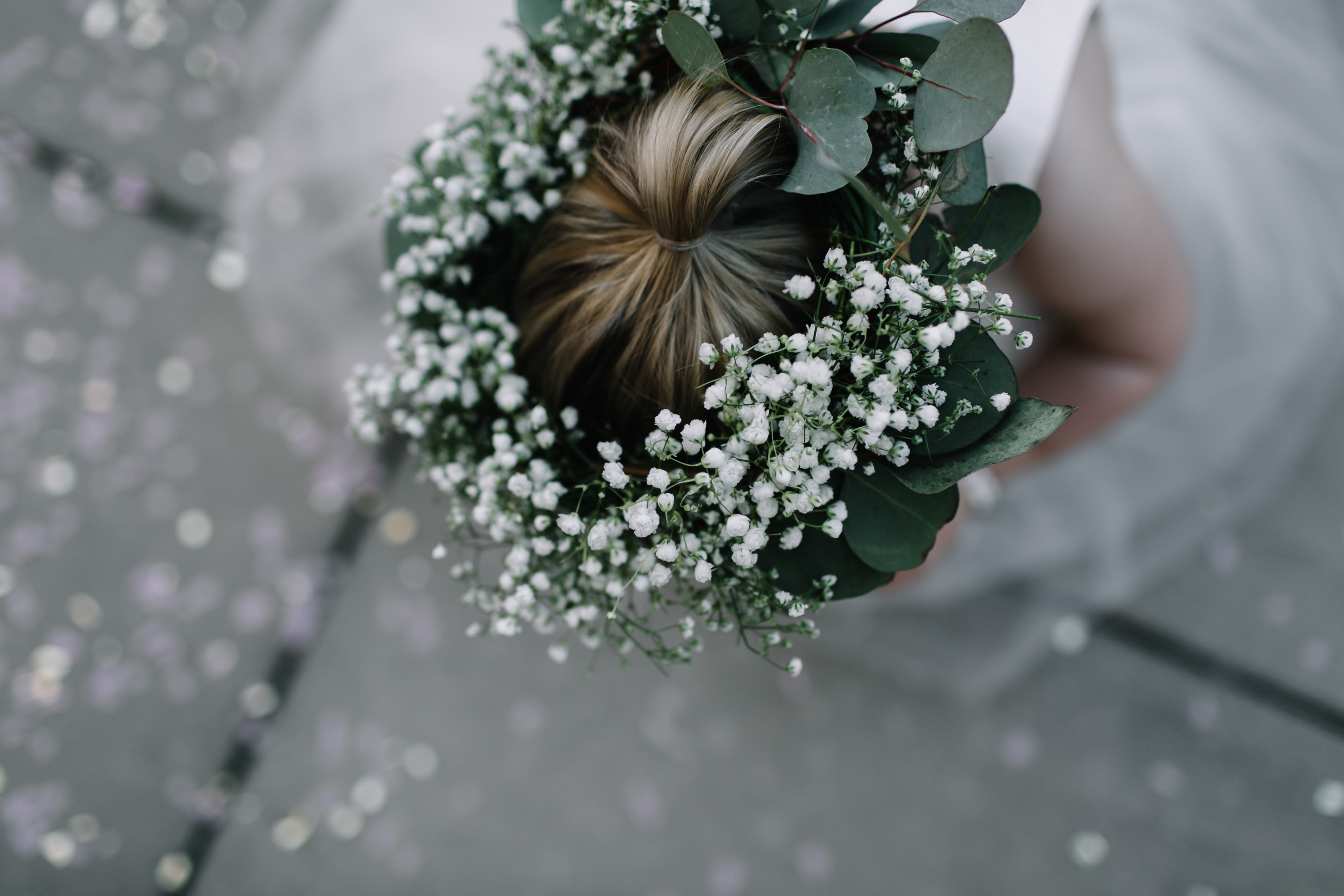 Floral crown with white baby's breath and eucalyptus on a person's hair