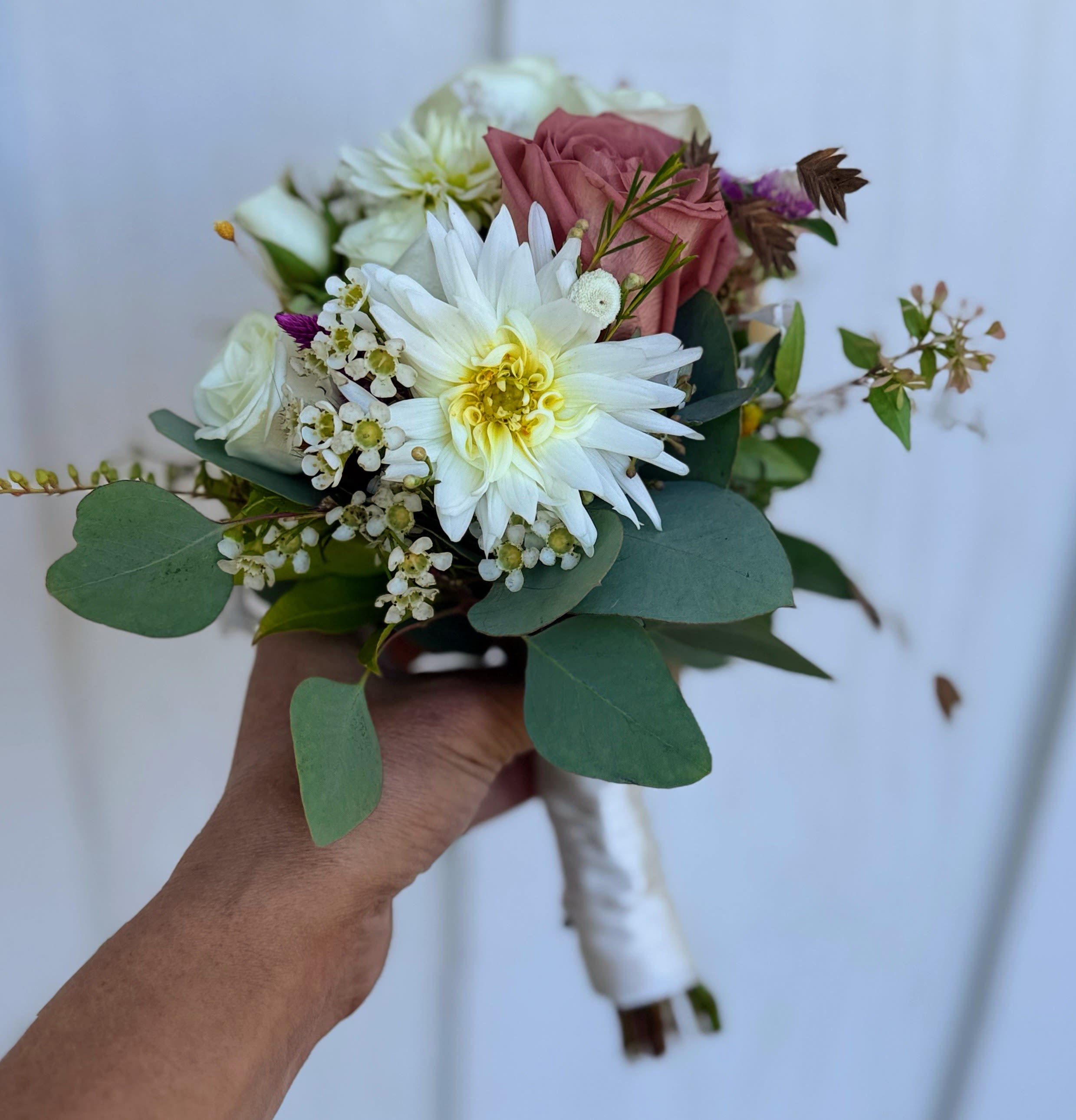 Handheld bouquet with white and pink flowers and eucalyptus