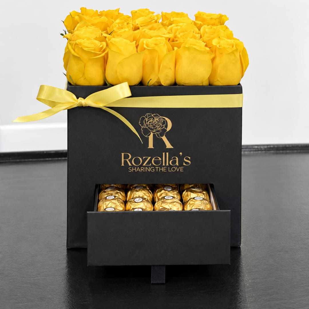 Yellow roses in a black gift box with a drawer of chocolates