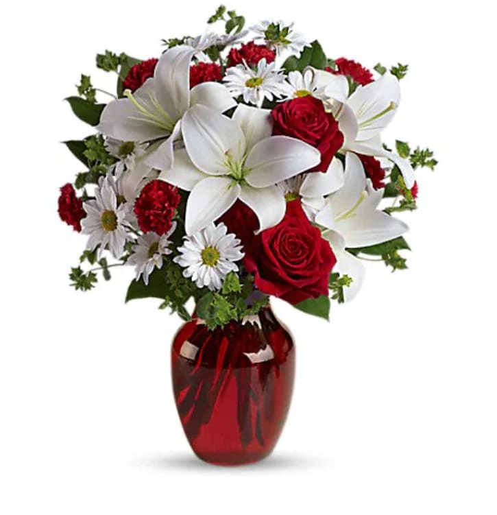 Be My Love Bouquet With Red Roses - The spirit of love and romance is beautifully captured in this enchanting bouquet. It's the perfect gift for anyone you love. Red roses and carnations are exquisitely arranged with white asiatic lilies and chrysanthemums in a ruby red glass vase. It's lovely.   Orientation : All-Around  All prices in USD ($)  Standard  T128-2A  Deluxe  T128-2B  Premium  T128-2C