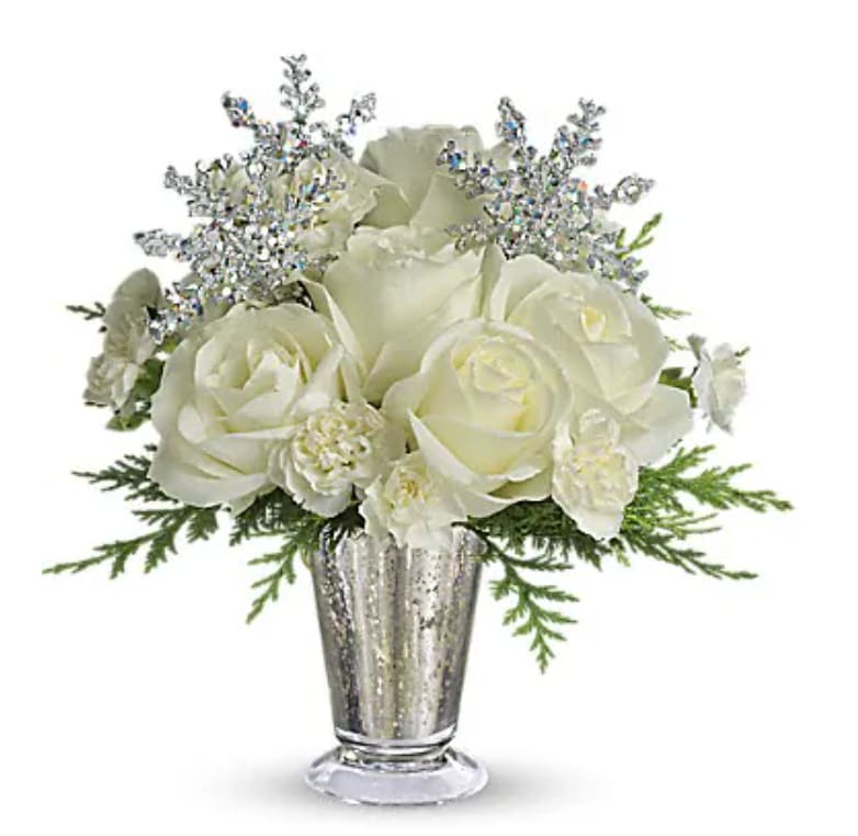 Winter Glow - Sparkling and splendid, this elegant arrangement is perfect for any winter celebration. It makes a spectacular centerpiece, amazing room accent, even an inspired anniversary gift. Especially if it's a silver anniversary! Gorgeous white roses, asiatic lilies and miniature carnations are beautifully arranged with magical silver snowflakes and delivered in a glamorous silver Mercury Glass Vase. Glow ahead and send this stunner today!   Orientation : All-Around  All prices in USD ($) 