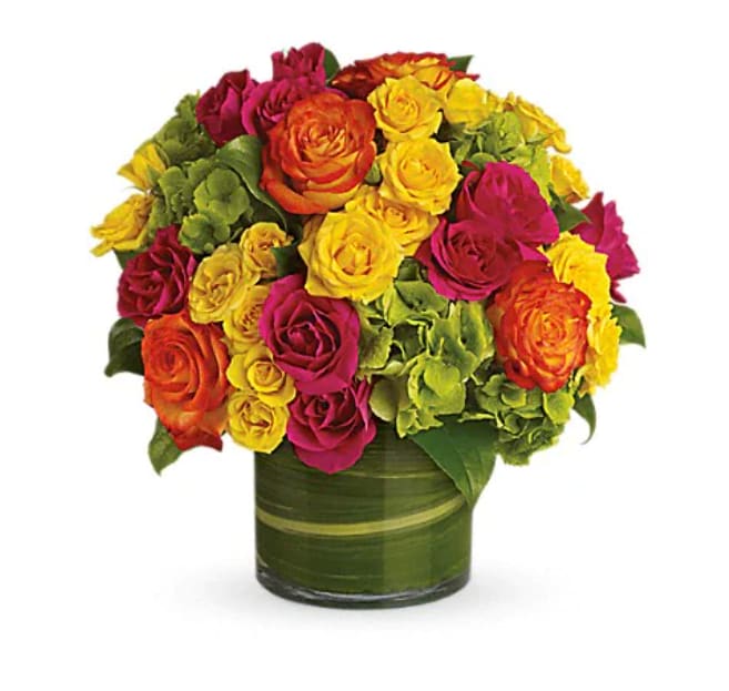 Mixed roses in yellow, pink, orange, and red arranged in a green vase