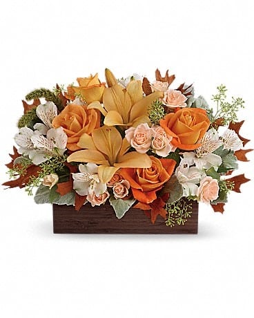Fall Chic Bouquet - Give any fall gathering a special chic feeling with this wonderful autumnal arrangement, featuring roses and lilies. Hand-delivered in a dark-toned bamboo rectangle. This impressive arrangement features light orange and peach roses, peach asiatic lilies and white alstroemeria, and finished with dusty miller, seeded eucalyptus and millet. Delivered in a Dark Bamboo Rectangle. 