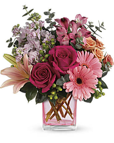 Painterly Pink Bouquet - Pretty as a painter's palette! Warm, wondrous shades of pink and peach play perfectly in this feminine bouquet that's artfully arranged in a pretty pink cube vase. What a fun, fabulous way to celebrate any occasion! This colorful arrangement includes hot pink roses, peach spray roses, pink asiatic lilies, pink gerberas, dark pink alstroemeria, pink stock, green hypericum, spiral eucalyptus and camellia leaves. Delivered in a pink cube vase. 