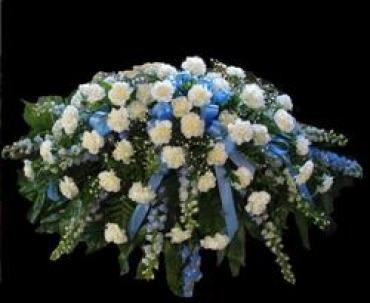 White and blue floral funeral spray with cascading ribbons