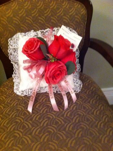 Small pillow with red roses and pink ribbons