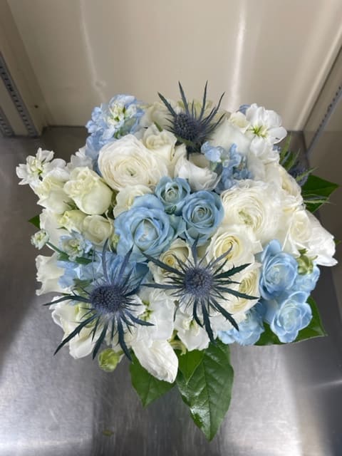 Blue and white bouquet with spiky thistle-like blooms