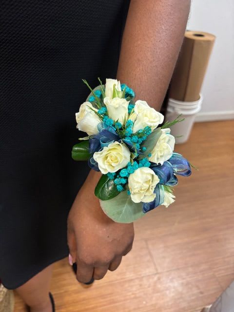 White rose wrist corsage with blue ribbon and turquoise accents