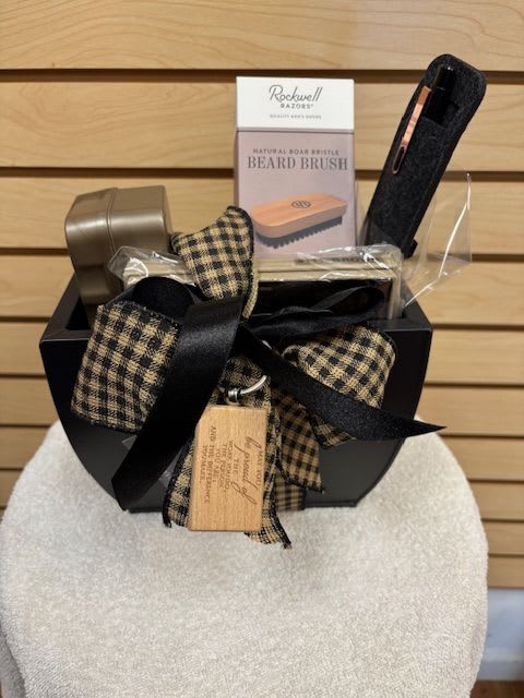 Gift basket with beard brush and grooming items tied with plaid ribbon