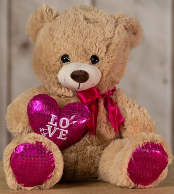 Plush teddy bear holding a pink heart with "LOVE" text