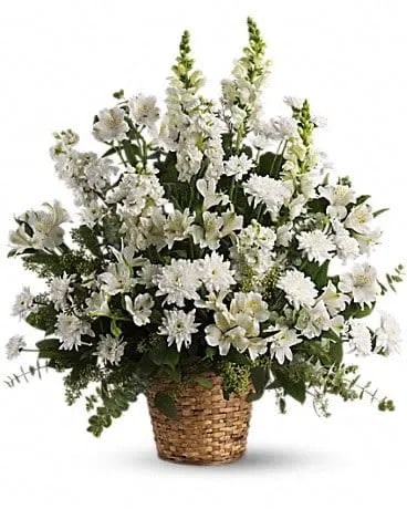 White floral arrangement in a woven basket