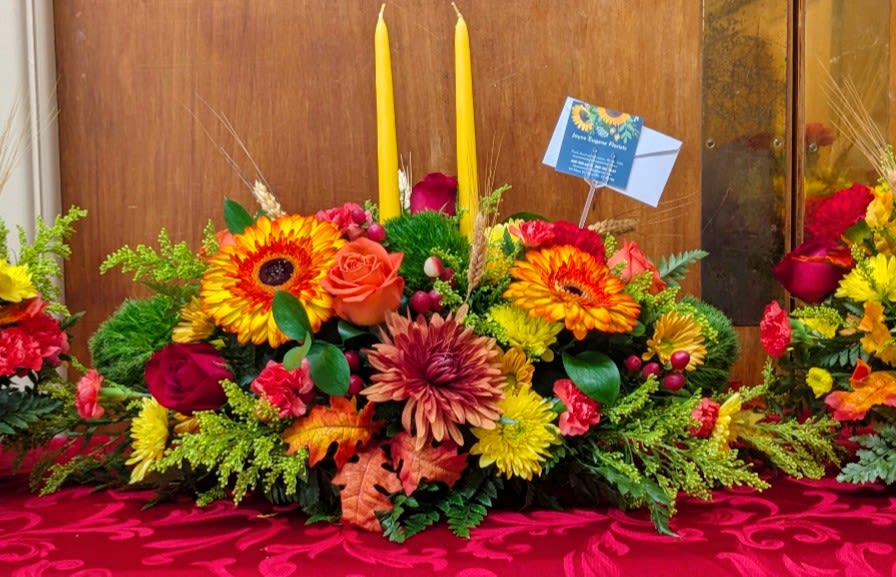 Long and Low centerpiece - Let our designers create a low and long centerpiece perfect for your feast's table. Centerpiece is guaranteed to have a variety of fall colored flowers and greenery.  *photos are samples, flower types are subject to change*