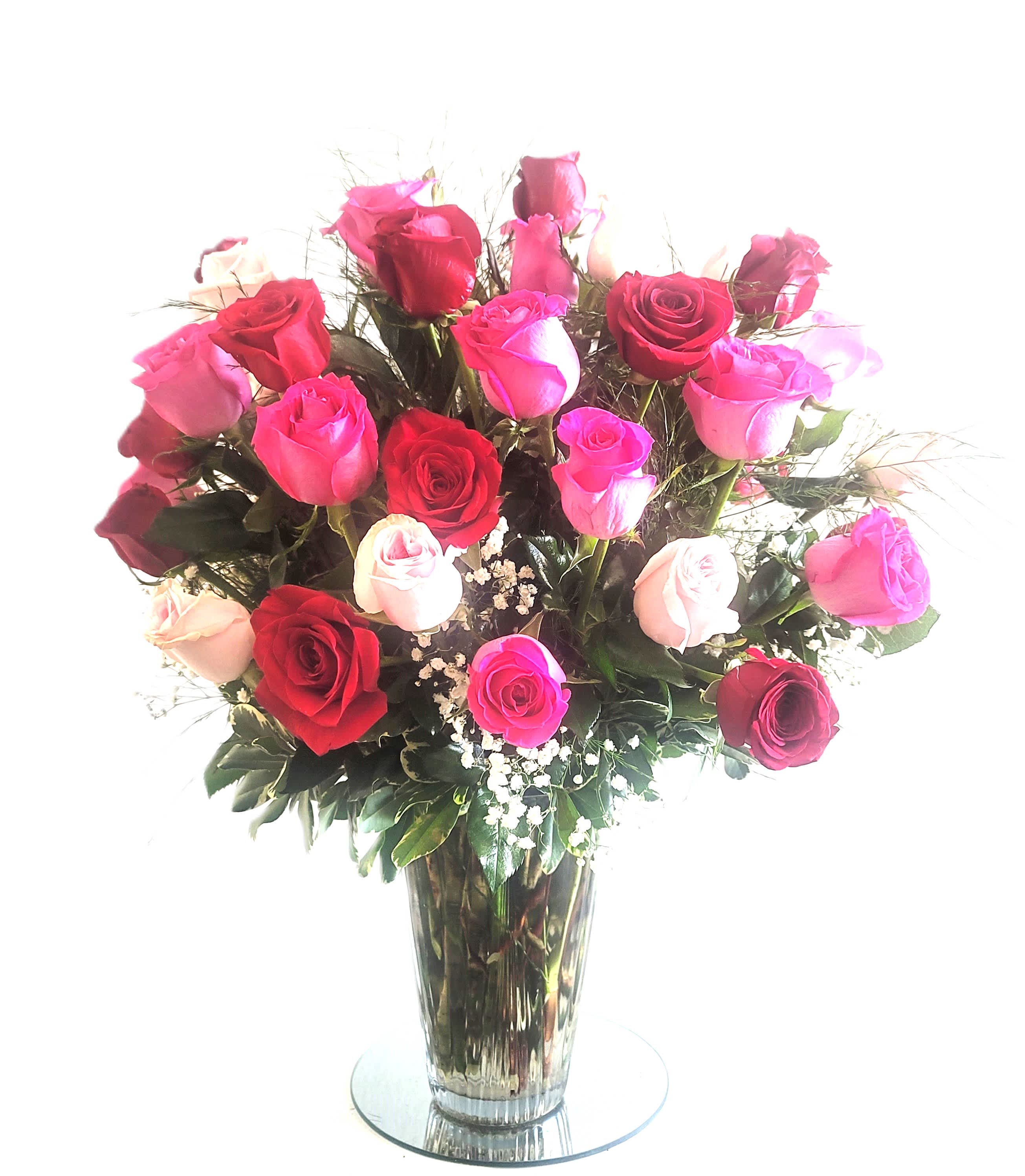 Bouquet of pink and red roses in a clear glass vase
